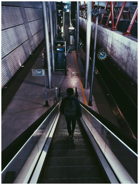 Traveler descending escalator in modern urban metr