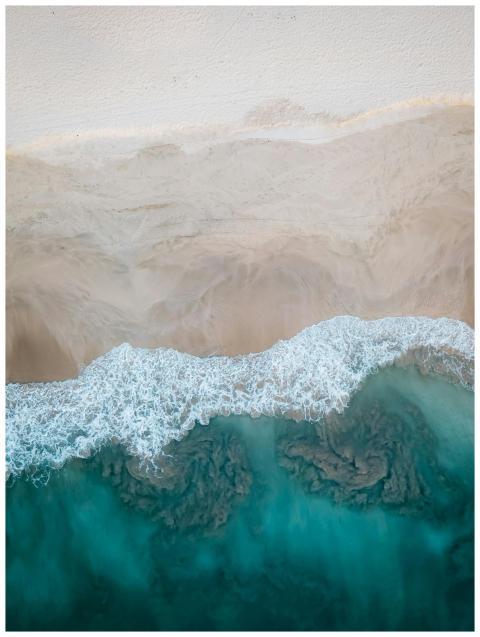 A stunning aerial view showcasing a sandy beach me