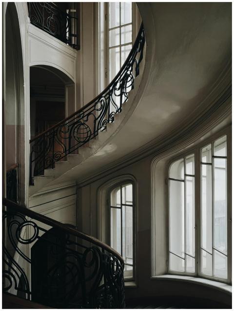 A stylish indoor staircase with intricate handrail