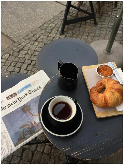 A cozy setup in Berlin featuring coffee, croissant