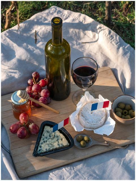 A charming French picnic with wine, cheese, and fr
