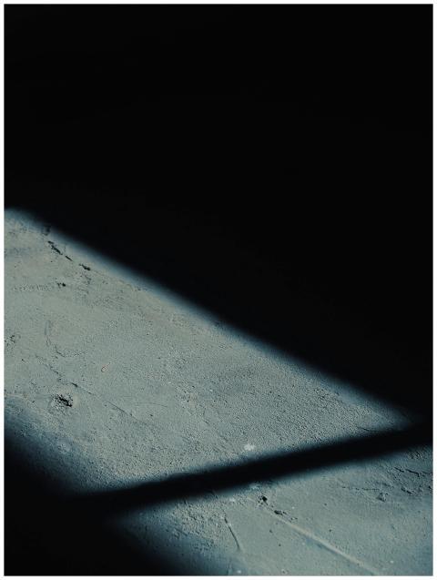 A dark and textured concrete surface with dramatic