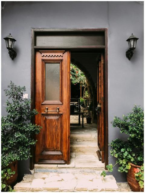 Explore a rustic wooden doorway leading to a lush