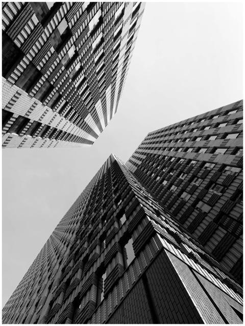 Dramatic view of modern high-rise buildings with g