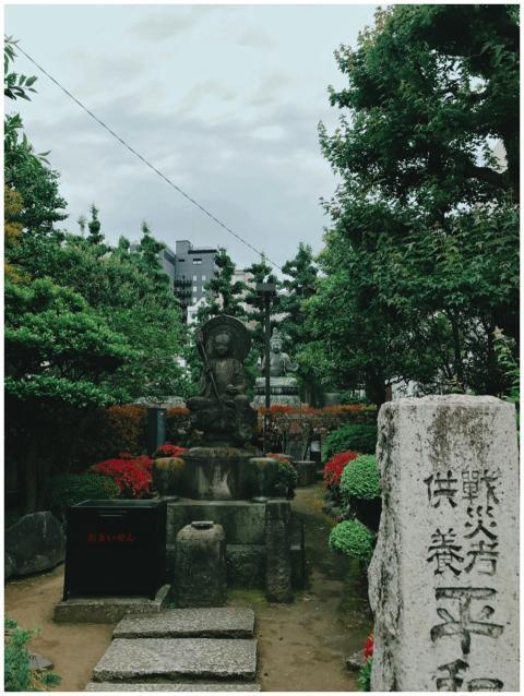 Serene Buddhist statue surrounded by lush greenery