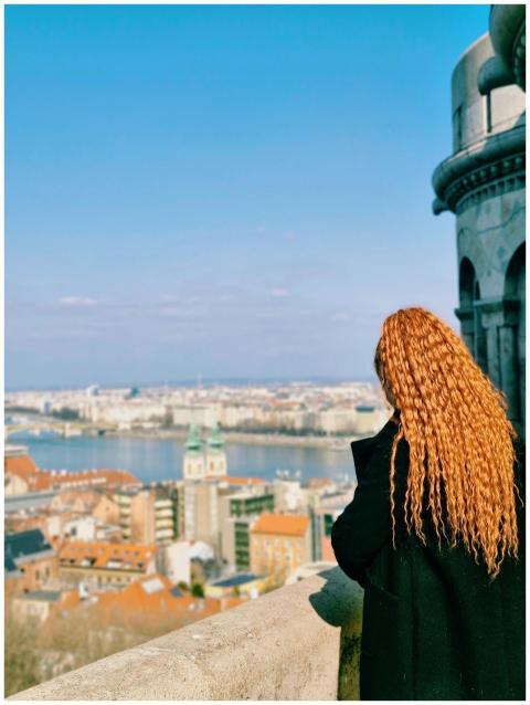 Woman with orange hair admiring Budapest's skyline