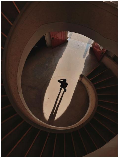 Artistic view of a spiral staircase casting a dram