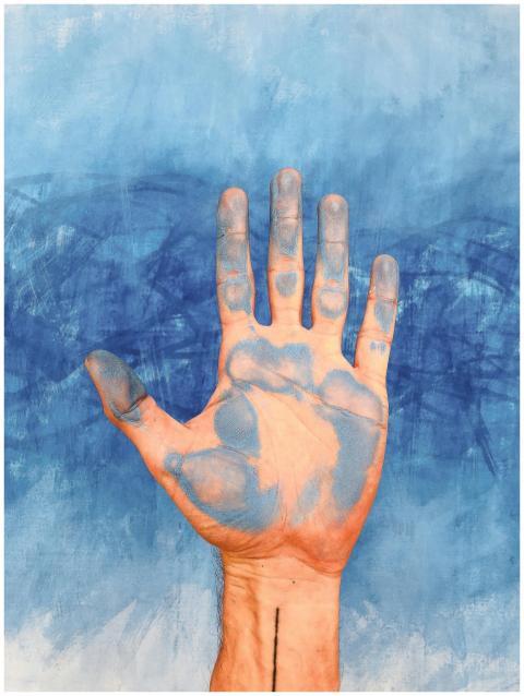 A hand covered in blue paint against a textured bl
