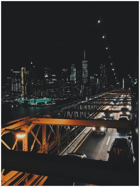 Illuminated New York City skyline from a bridge, f