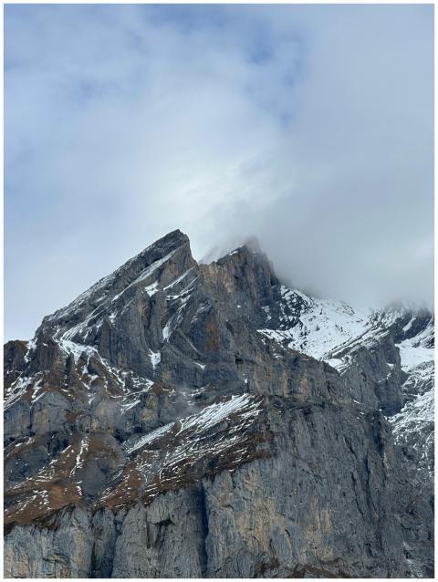 Stunning view of a high mountain peak partially co
