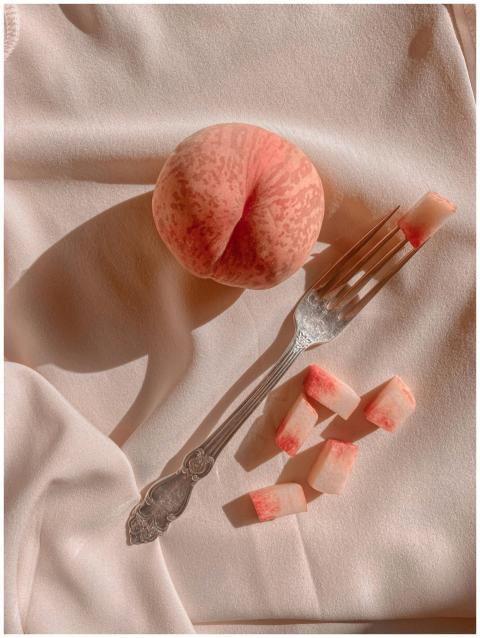 Elegant composition of a ripe peach with slices an