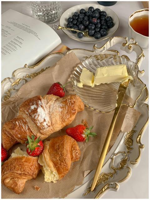 Elegant arrangement of croissants, strawberries, b