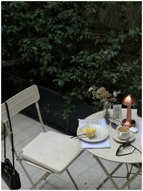 Elegant outdoor café setting with coffee, dessert,