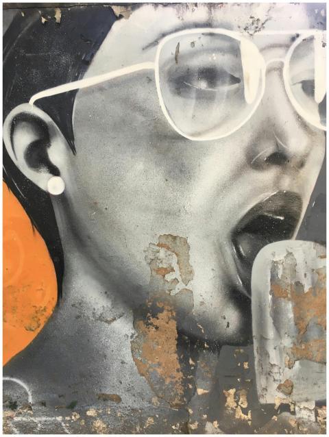 Dynamic street art mural featuring a vivid portrai