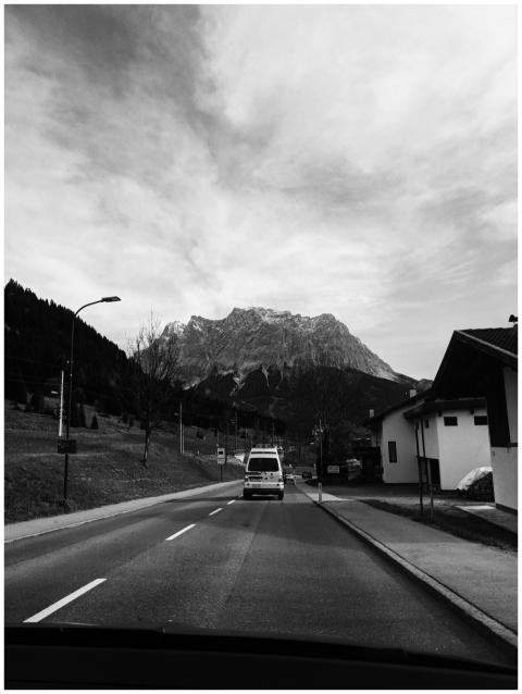 Monochrome image of a road vanishing into Austrian