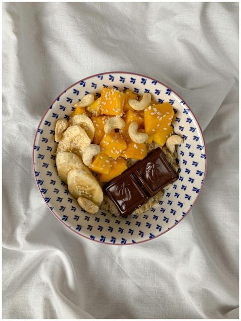 Healthy breakfast bowl with mango, banana, cashews