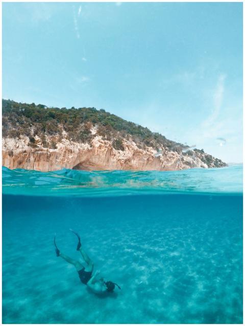 A serene over-under photograph capturing a diver e
