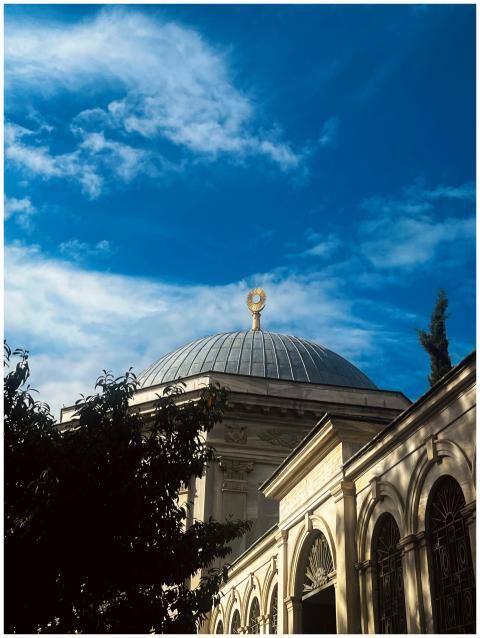 A stunning dome under a bright blue sky with archi