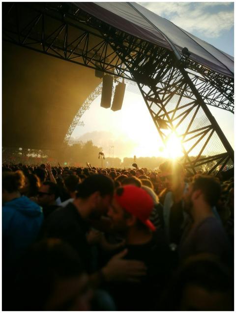 Energetic crowd at an outdoor music festival durin