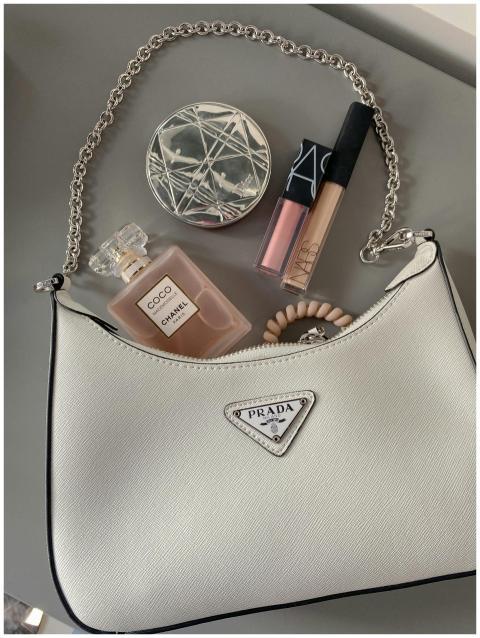 Elegant flatlay featuring a luxury handbag with ma