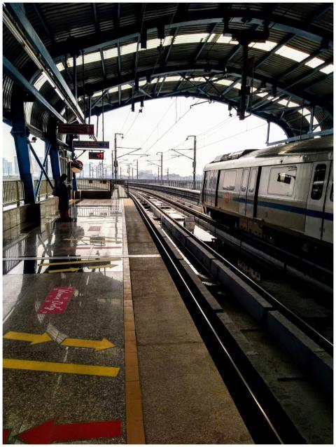 A sleek commuter train arrives at an urban station