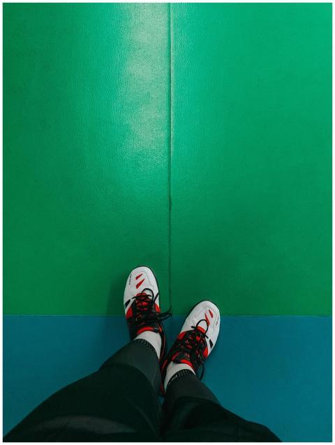 Person wearing trendy sneakers on a vibrant indoor