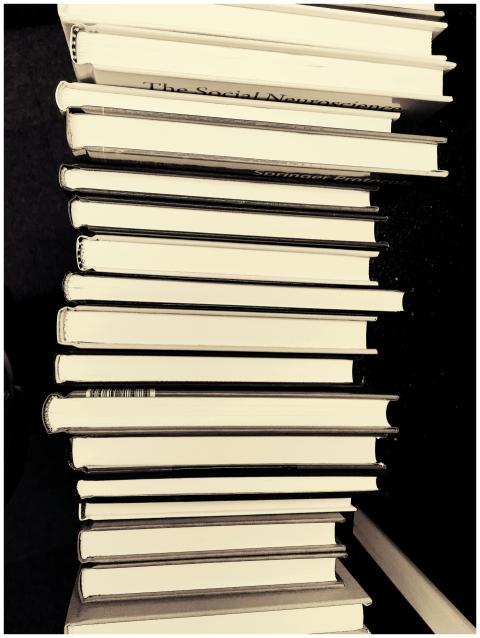 Monochrome image of a stack of books in a library