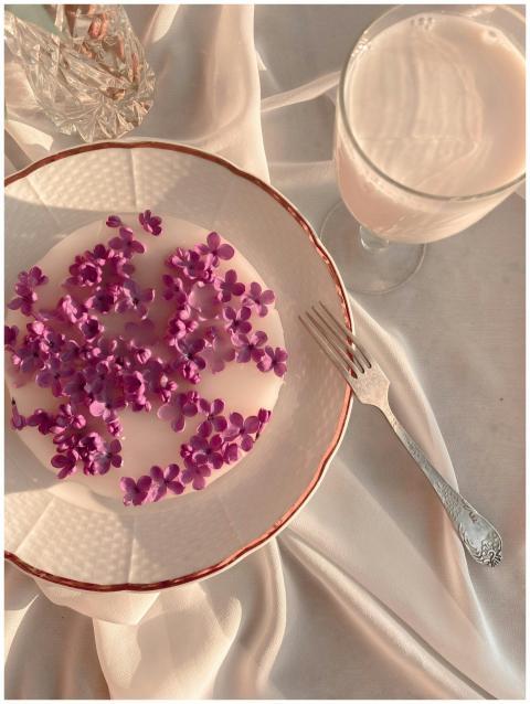 A serene breakfast scene featuring lilacs on a pla