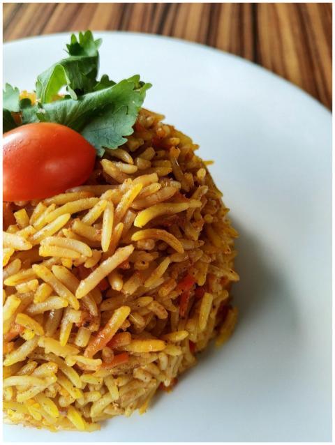 Delicious biryani rice garnished with tomato and c
