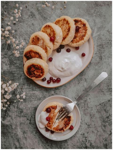Delicious rustic pancakes served with cream and cr