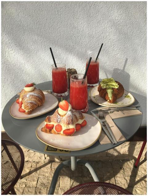 Tasty croissants with fruit and smoothies on an ou