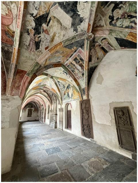 Intricate frescoes adorn the vaulted ceilings of a