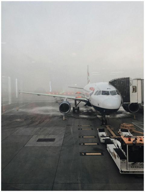 A commercial airplane on a foggy runway at Gatwick