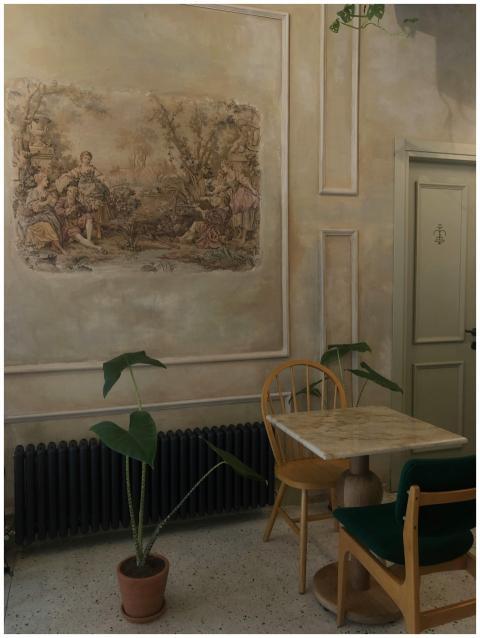 Interior of cozy elegant cafe with painting on wal