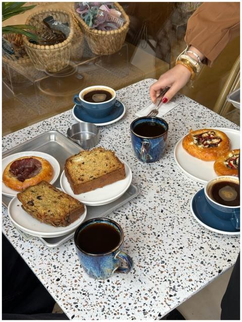 Stylish café table with pastries and coffee, perfe
