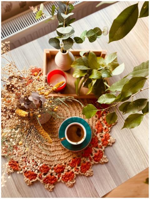 A warm, inviting table setup with a coffee cup, pl