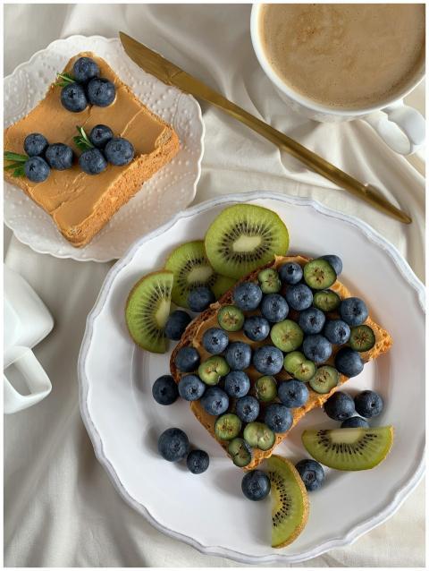 Appetizing toast topped with blueberries and kiwi,