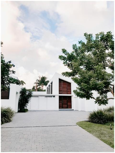 Contemporary minimalist home exterior with lush la