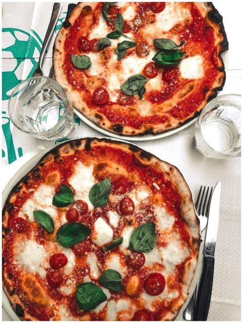 Two delicious pizzas topped with mozzarella and ba