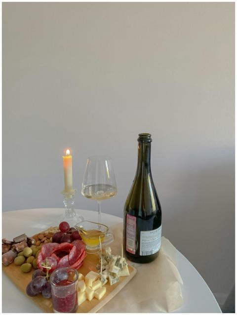 A sophisticated charcuterie board with wine and ca