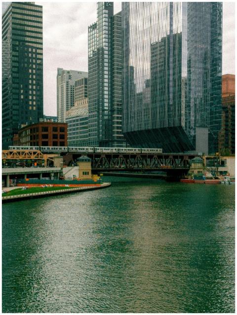 A train crosses a bridge over the Chicago River wi