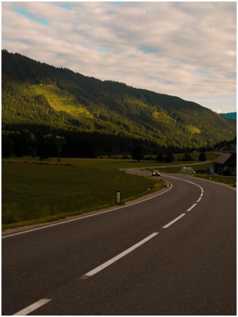 Curving road in Rakúsko under a dramatic evening s