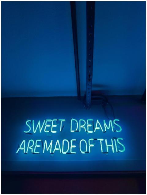 Illuminated neon sign reading 'Sweet Dreams Are Ma