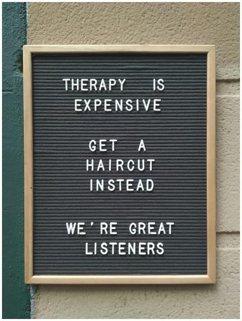 Funny hair salon sign suggesting haircuts over the
