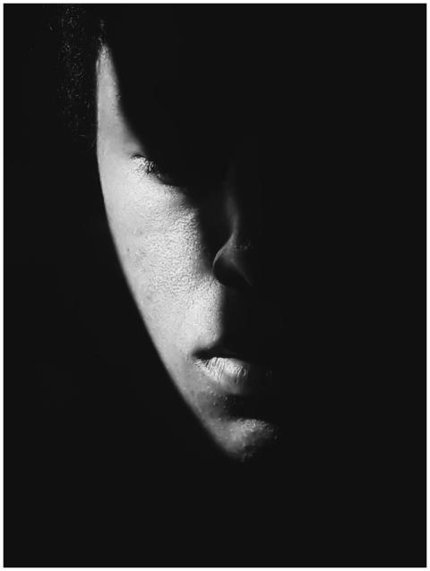 Moody black and white portrait of a man with drama