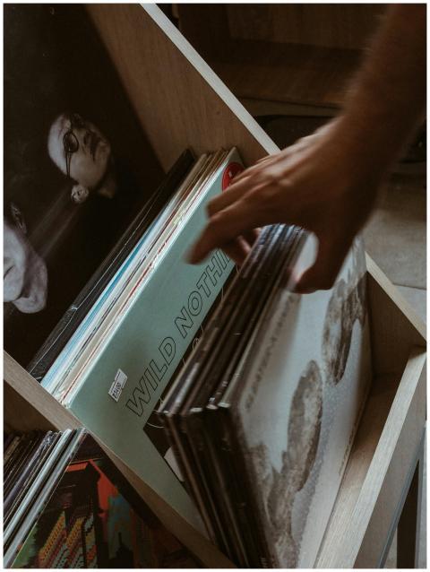 Close-up of a hand browsing vintage vinyl records