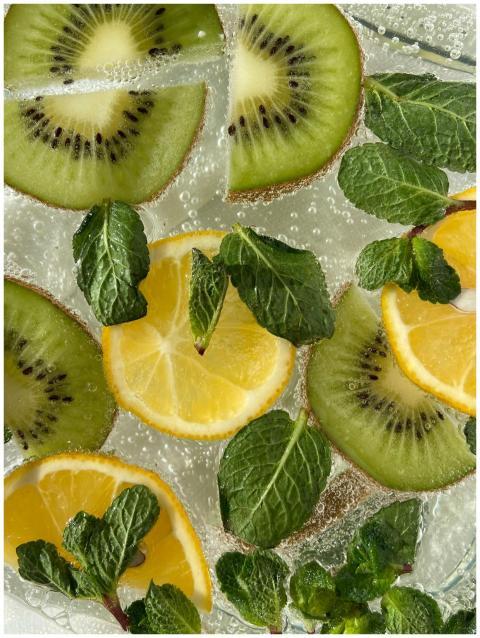 Vibrant citrus and kiwi slices with mint leaves in