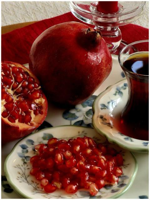 Pomegranate seeds and tea create a vibrant still l