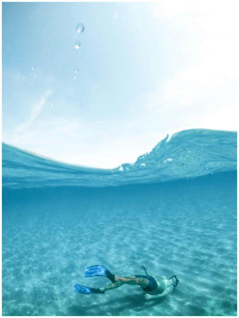A snorkeler enjoys the crystal-clear waters of Sar