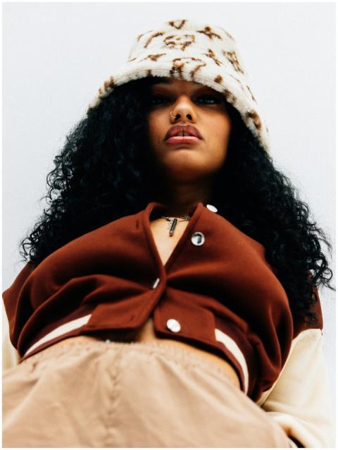 A fashionable woman wearing a brown outfit with a